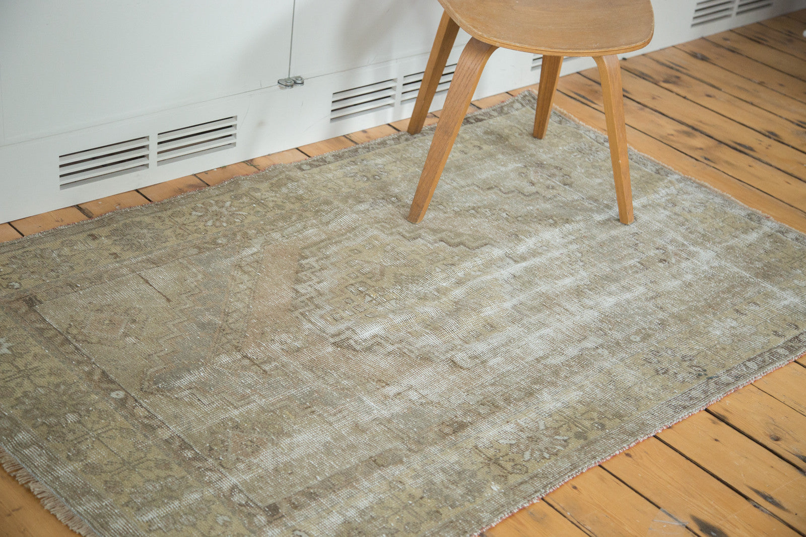 Distressed Oushak rug with faded octagonal medallion and geometric border in muted earth tones.